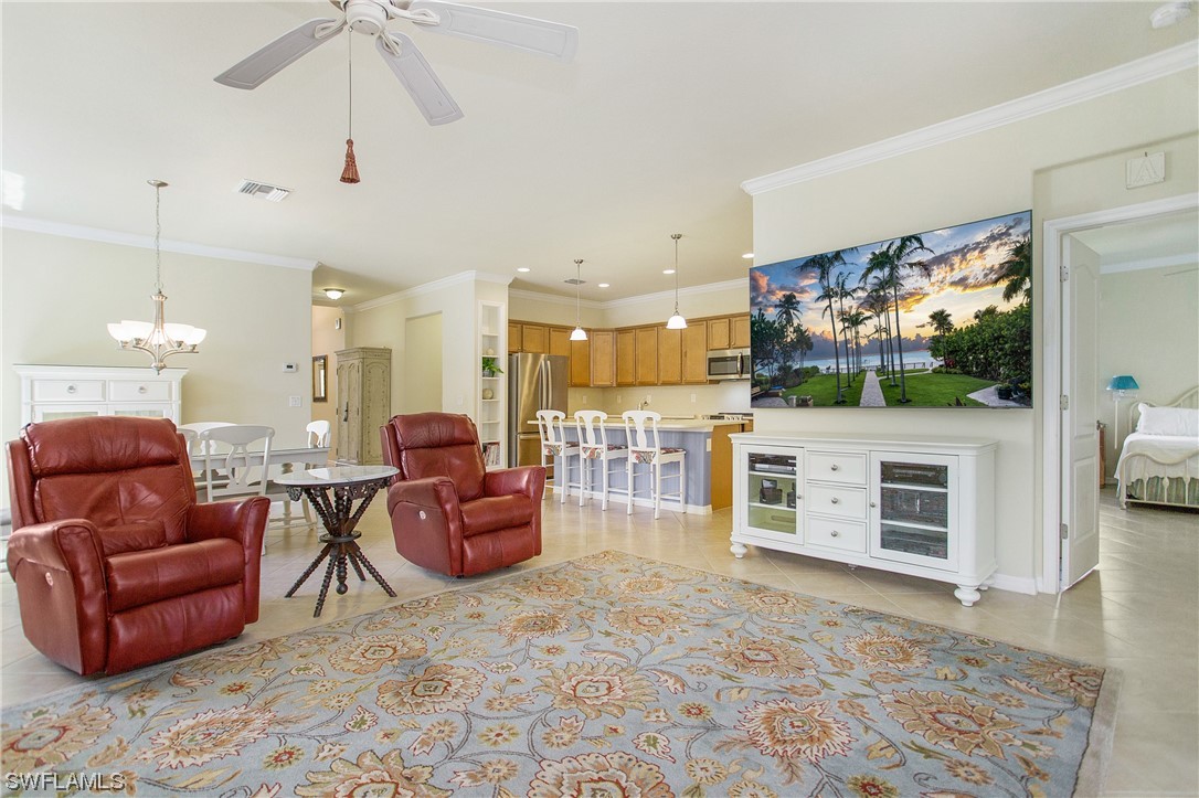 7948 Princeton Drive Naples, FL 34104 - Photo 8 of 35 a living room with furniture and a flat screen tv