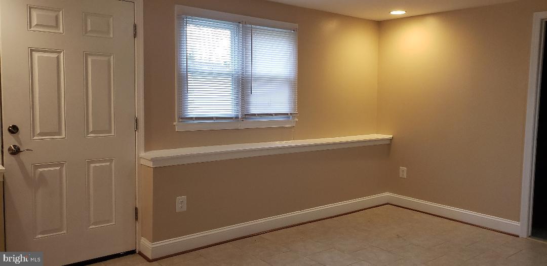 9207 4th Street Lanham, MD 20706 - Photo 6 of 14 a view of an empty room with a window