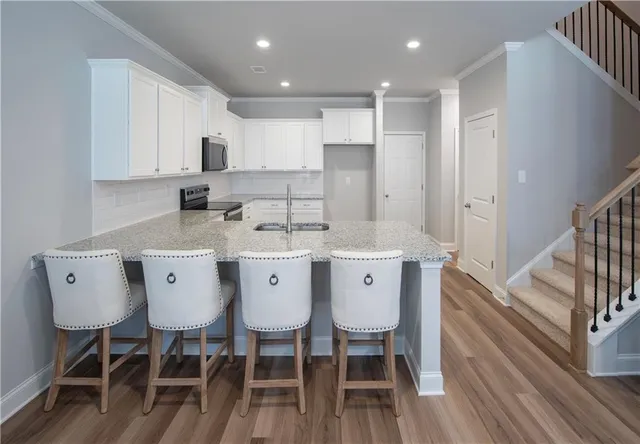 a view of kitchen with cabinets table and chairs