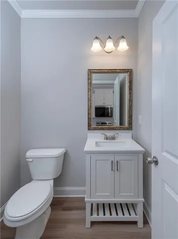 a bathroom with a toilet a sink and a mirror