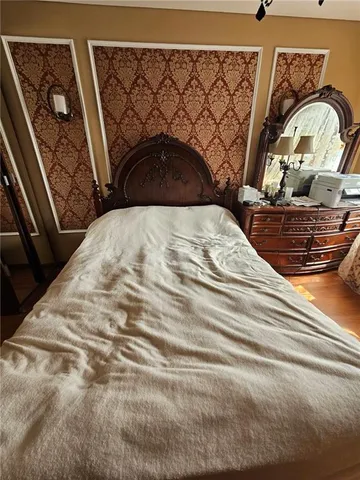 a bedroom with a bed and a mirror