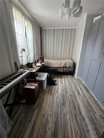 a room with wooden floor and furniture