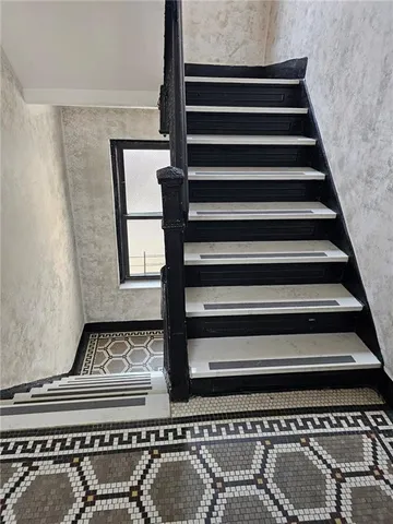 a view of staircase with white walls