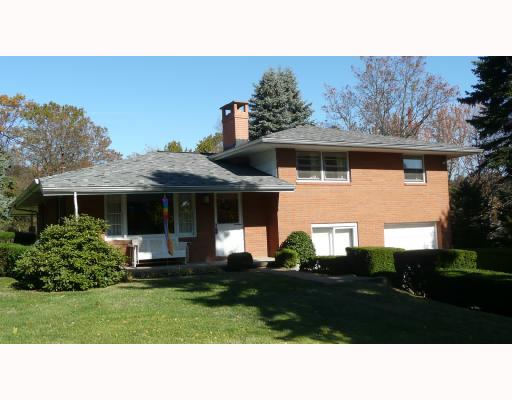 Exterior Front. Solid brick custom built multi level home with long paved driveway.