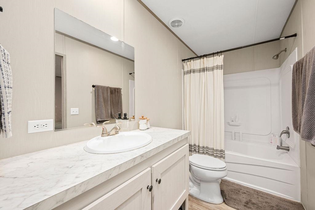 271 Clements Way Fruita, CO 81521 - Photo 12 of 26 a bathroom with a granite countertop sink toilet mirror and shower