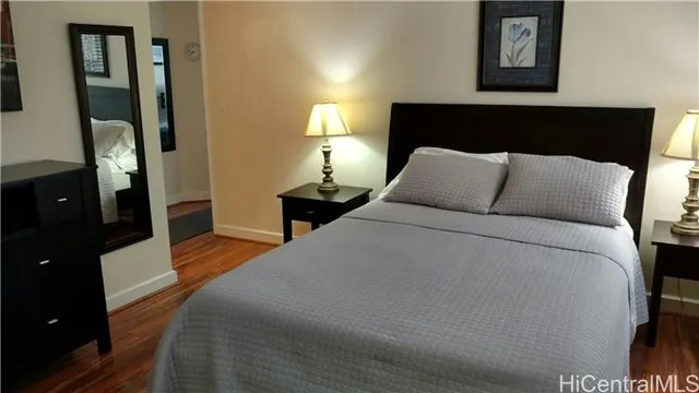 a large bed sitting in a bedroom next to a lamp