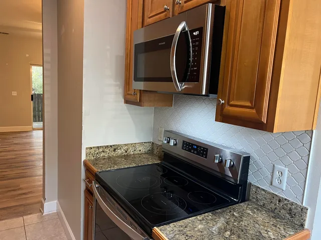 a kitchen with a stove and a microwave