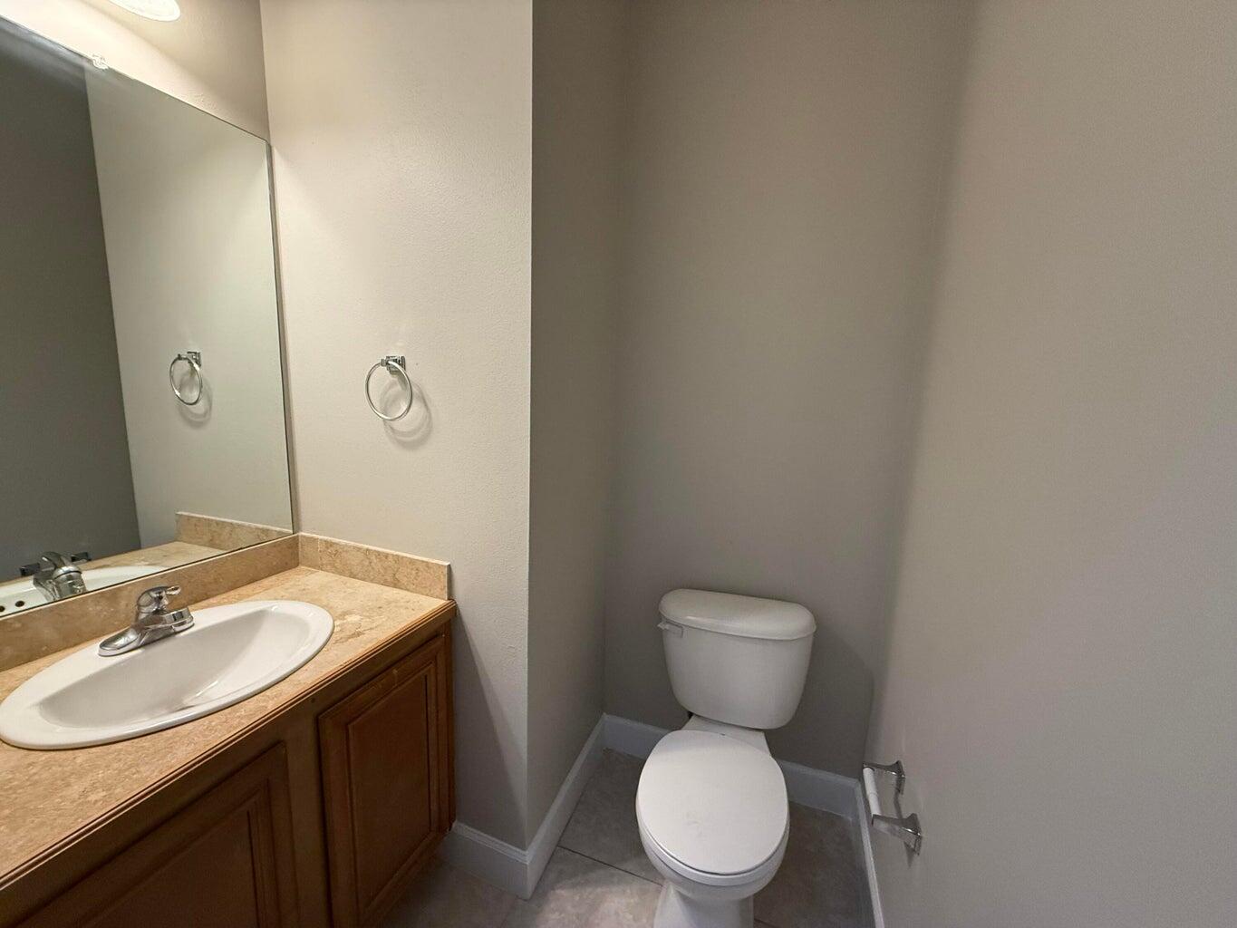 15284 331 Business, Unit 13B Freeport, FL 32439 - Photo 4 of 9 a bathroom with a toilet sink vanity and mirror