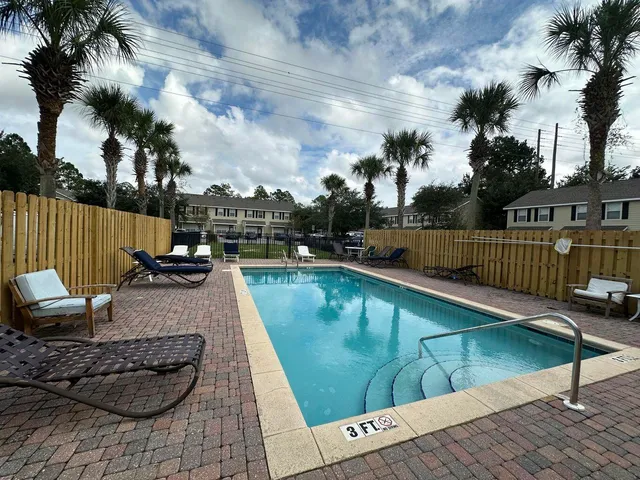 a view of a swimming pool with a lounge chairs