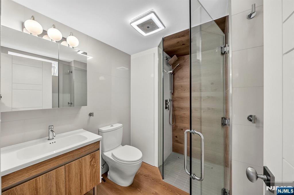 57 Hemlock Road Little Falls, NJ 07424 - Photo 37 of 50 a bathroom with a granite countertop sink toilet and shower