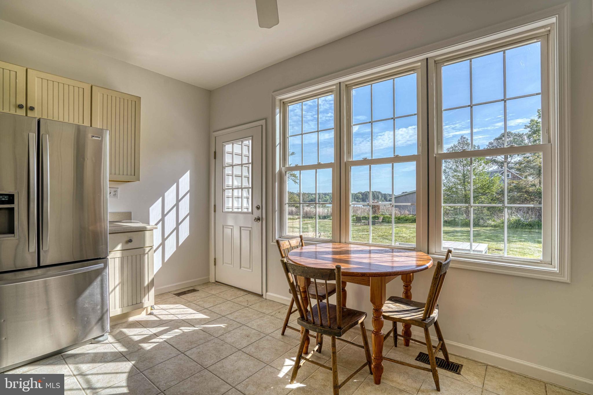 6403 Bozman Neavitt Road Neavitt, MD 21652 - Photo 12 of 31 a dining room with furniture and a floor to ceiling window