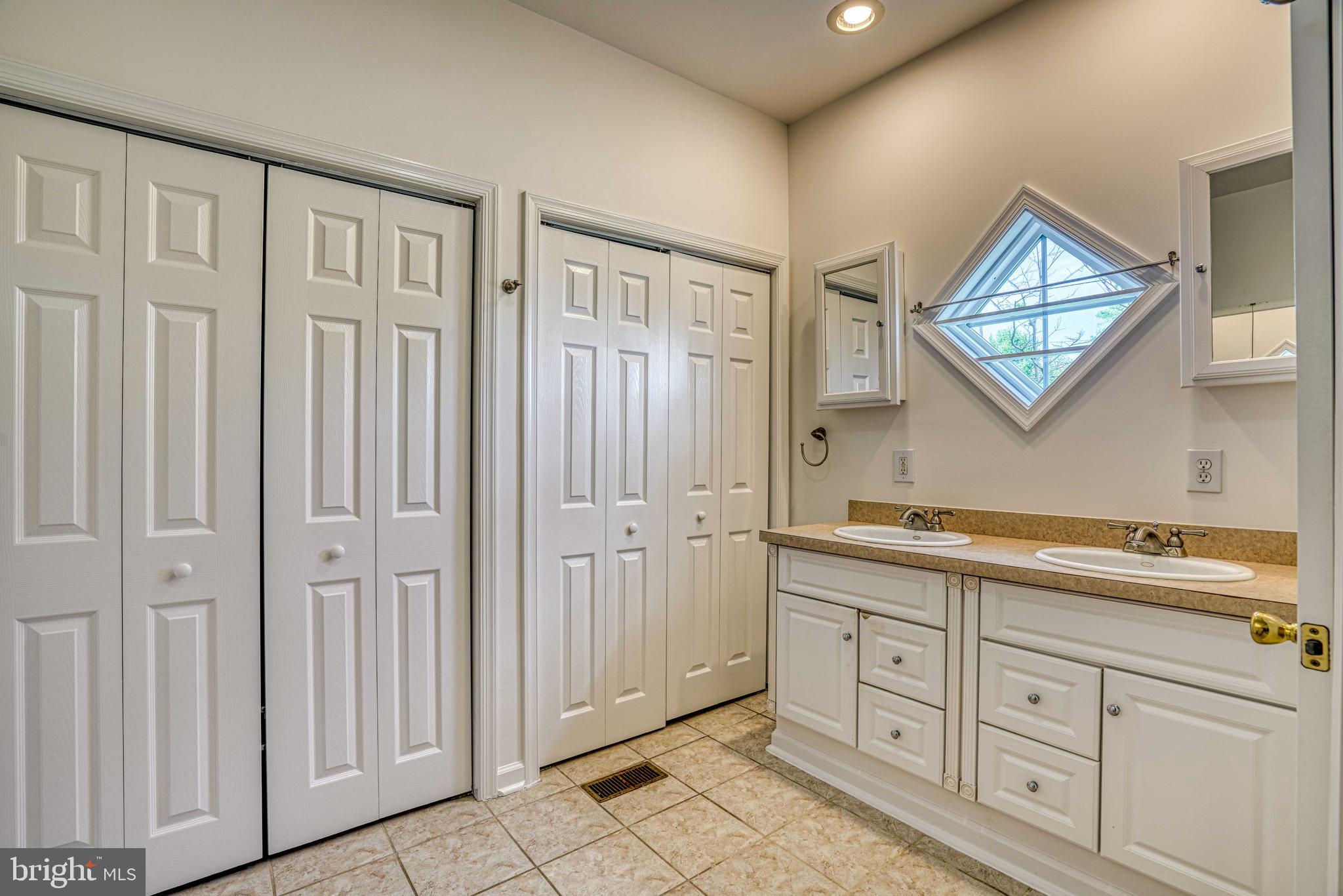 6403 Bozman Neavitt Road Neavitt, MD 21652 - Photo 14 of 31 a spacious bathroom with a double vanity sink a mirror and a shower