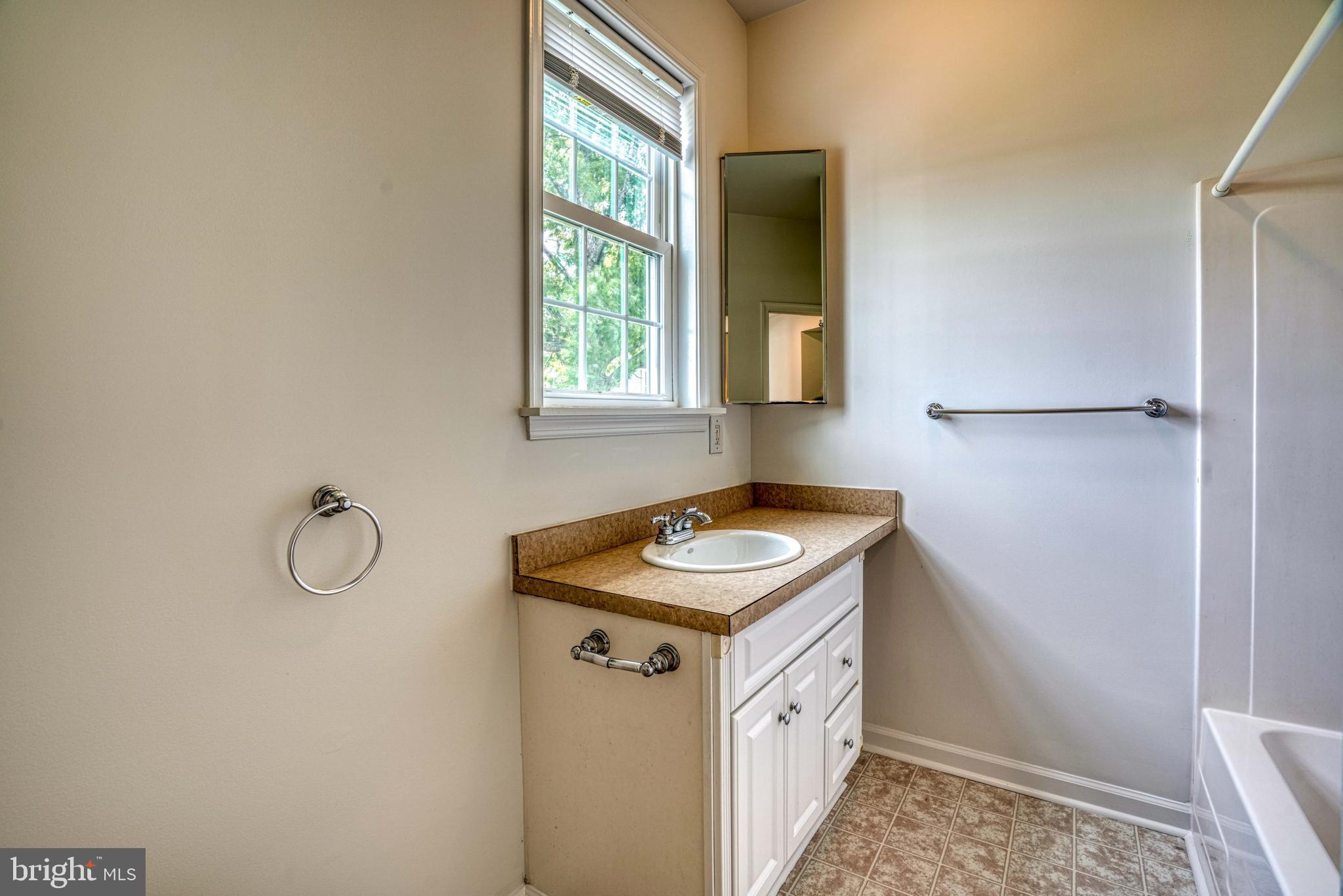 6403 Bozman Neavitt Road Neavitt, MD 21652 - Photo 18 of 31 a bathroom with a granite countertop sink and a window