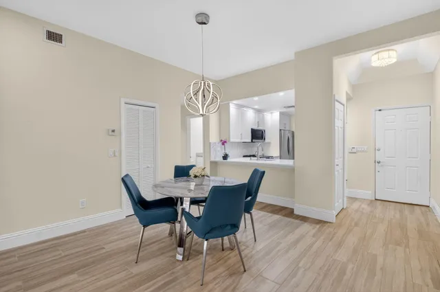 a kitchen with appliances a refrigerator and a sink
