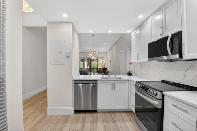 a view of a hallway with closet and wooden floor