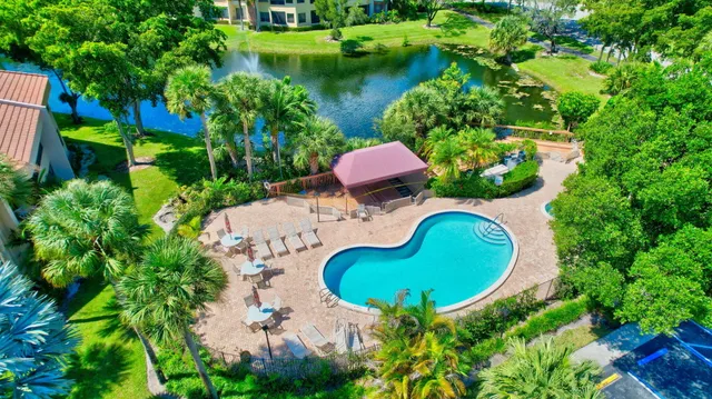 an aerial view of a house with swimming pool patio and outdoor seating