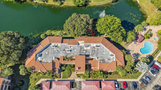 an aerial view of residential houses with outdoor space and lake view