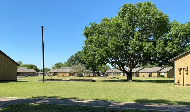 a view of a house with yard and tree s