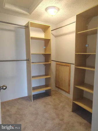 a view of an empty room with empty shelves