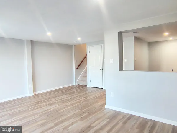 a view of an empty room with wooden floor