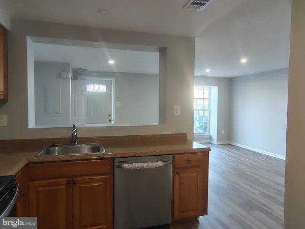 a kitchen with granite countertop a sink and cabinets