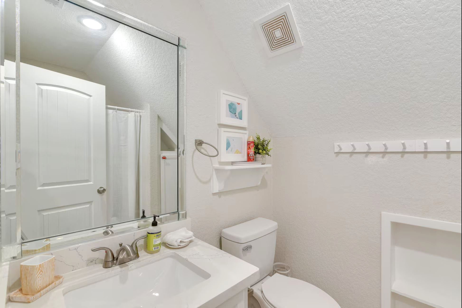 315 Murex Street Surfside Beach, TX 77541 - Photo 21 of 29 a bathroom with a sink mirror vanity and toilet