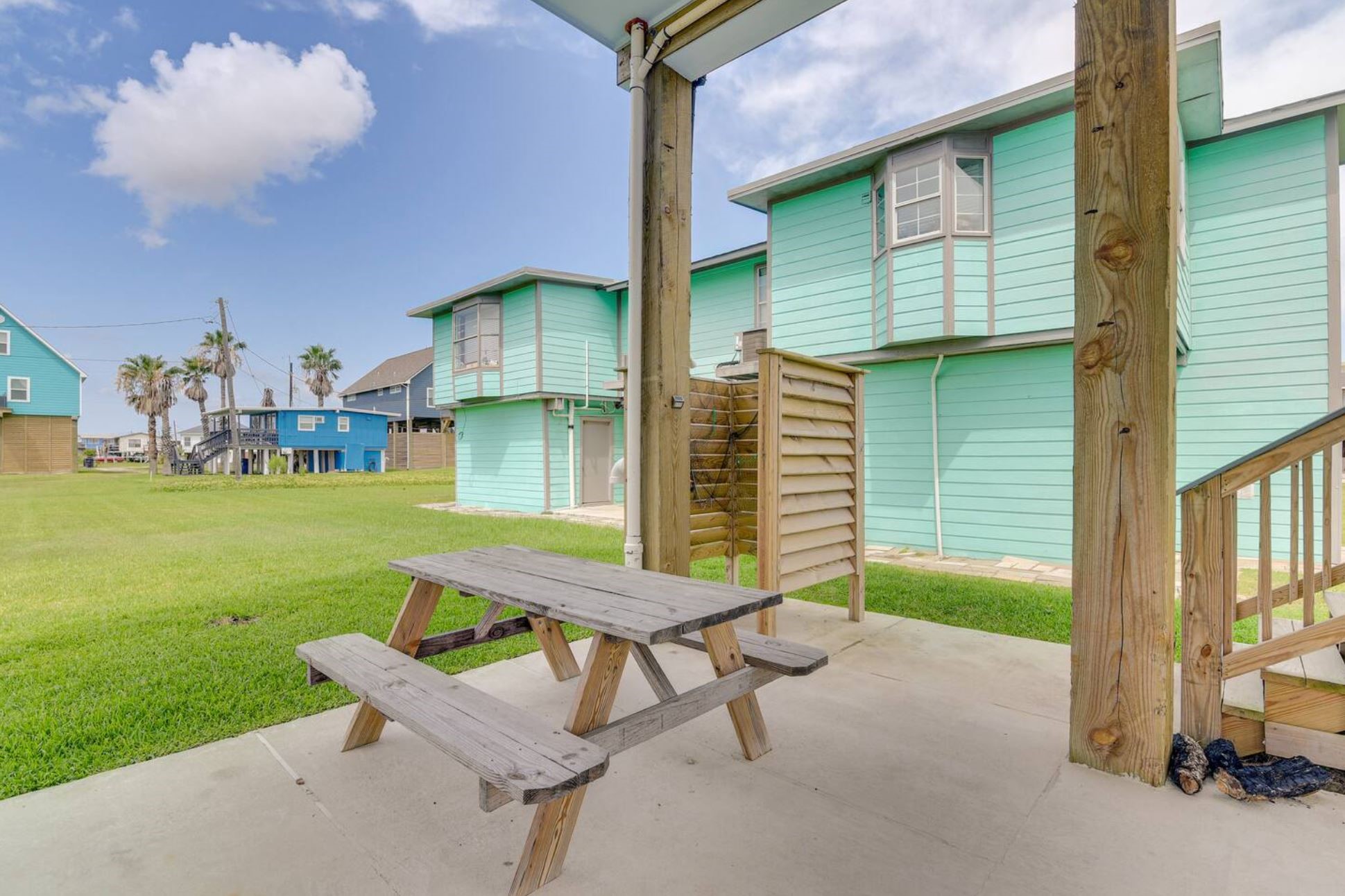 315 Murex Street Surfside Beach, TX 77541 - Photo 27 of 29 a view of a patio with table and chairs and potted plants