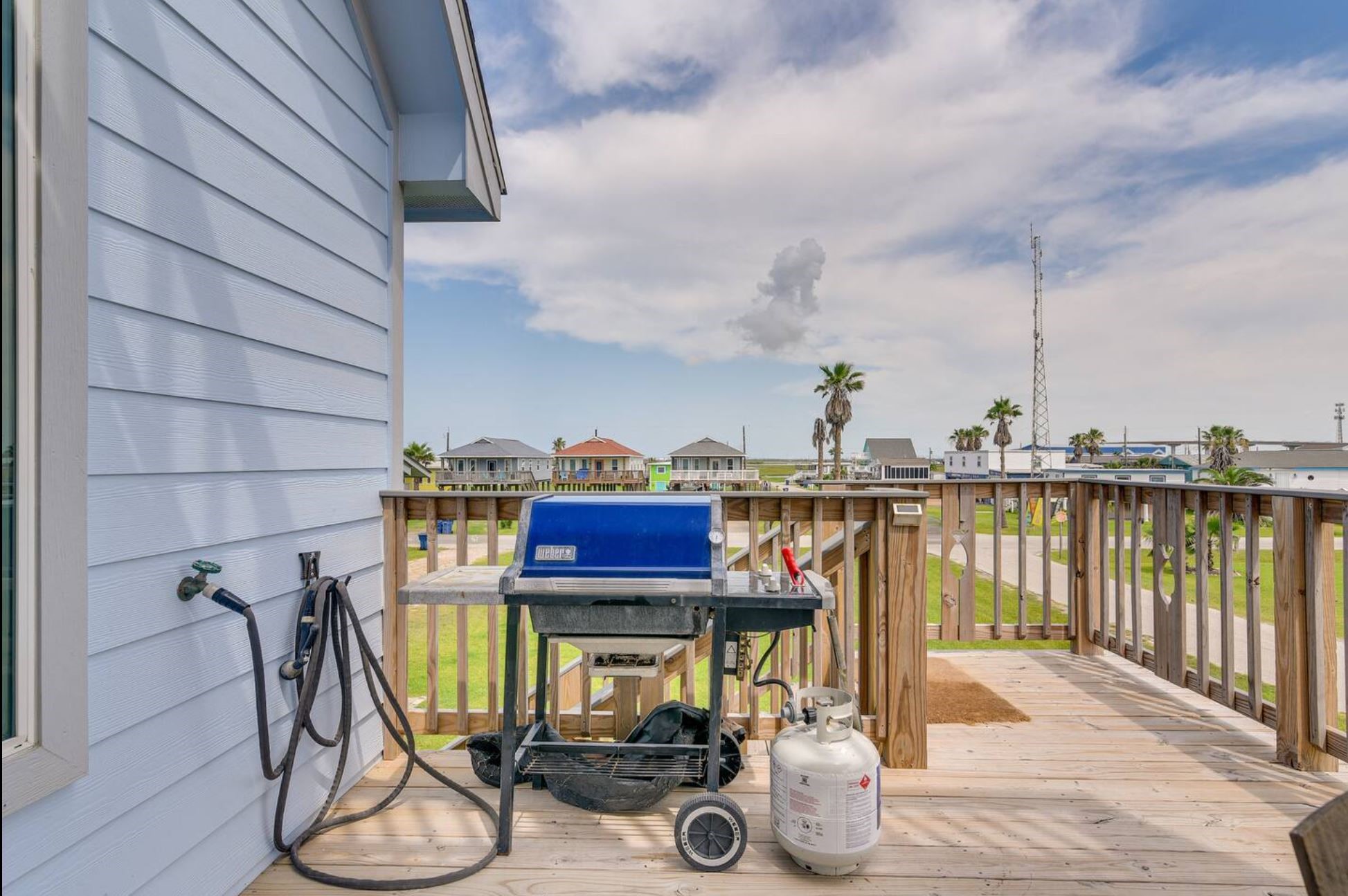 315 Murex Street Surfside Beach, TX 77541 - Photo 3 of 29 a view of a balcony with chairs and wooden floor