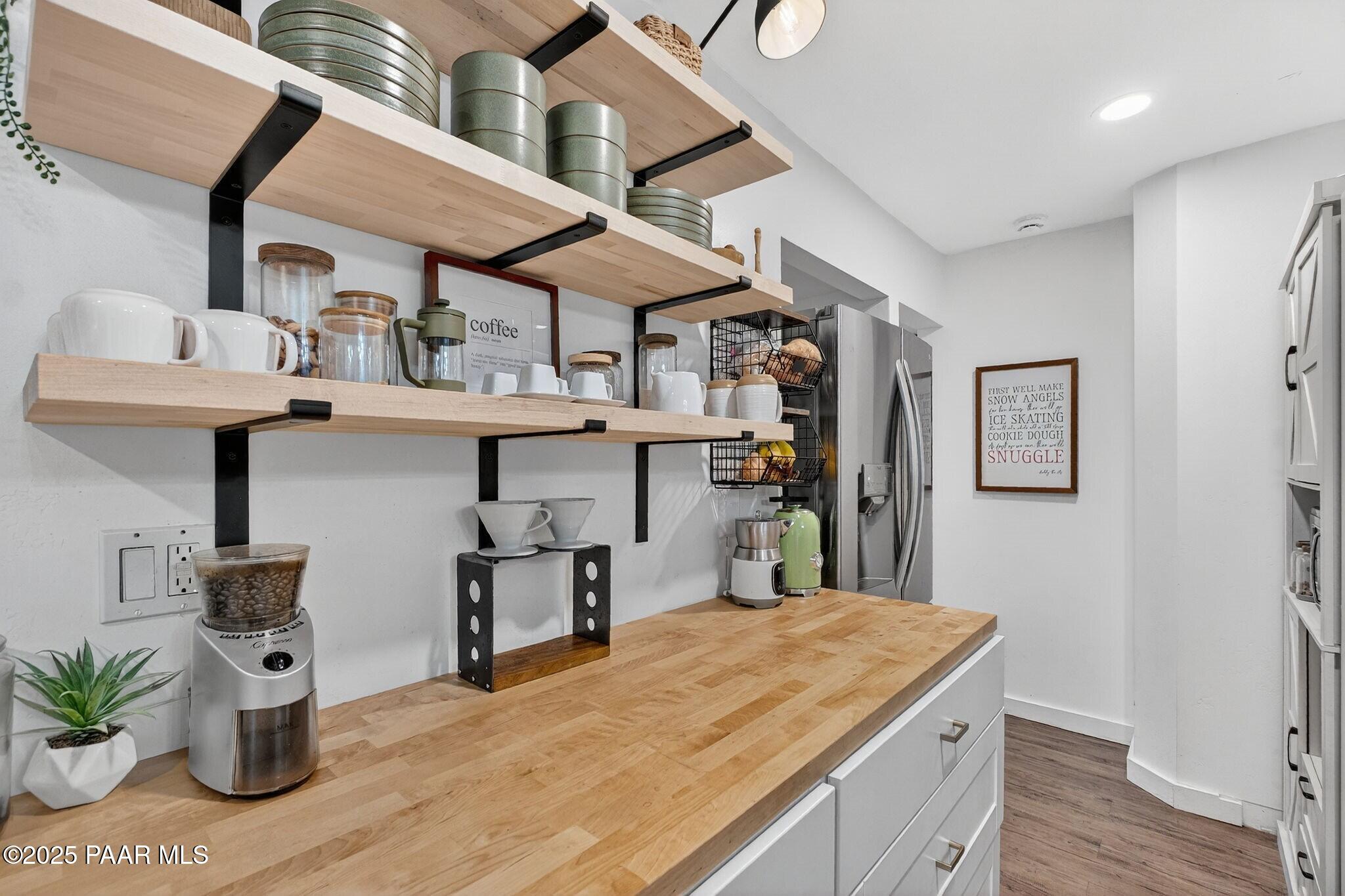 730 4th Street Prescott, AZ 86301 - Photo 11 of 37 a kitchen with stainless steel appliances kitchen island a table and chairs in it