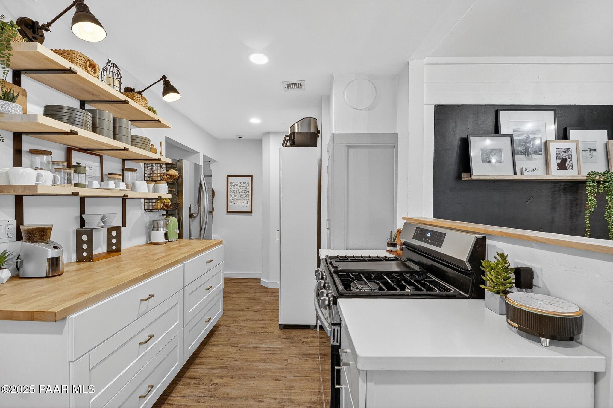 730 4th Street Prescott, AZ 86301 - Photo 13 of 37 a kitchen with a stove and cabinets
