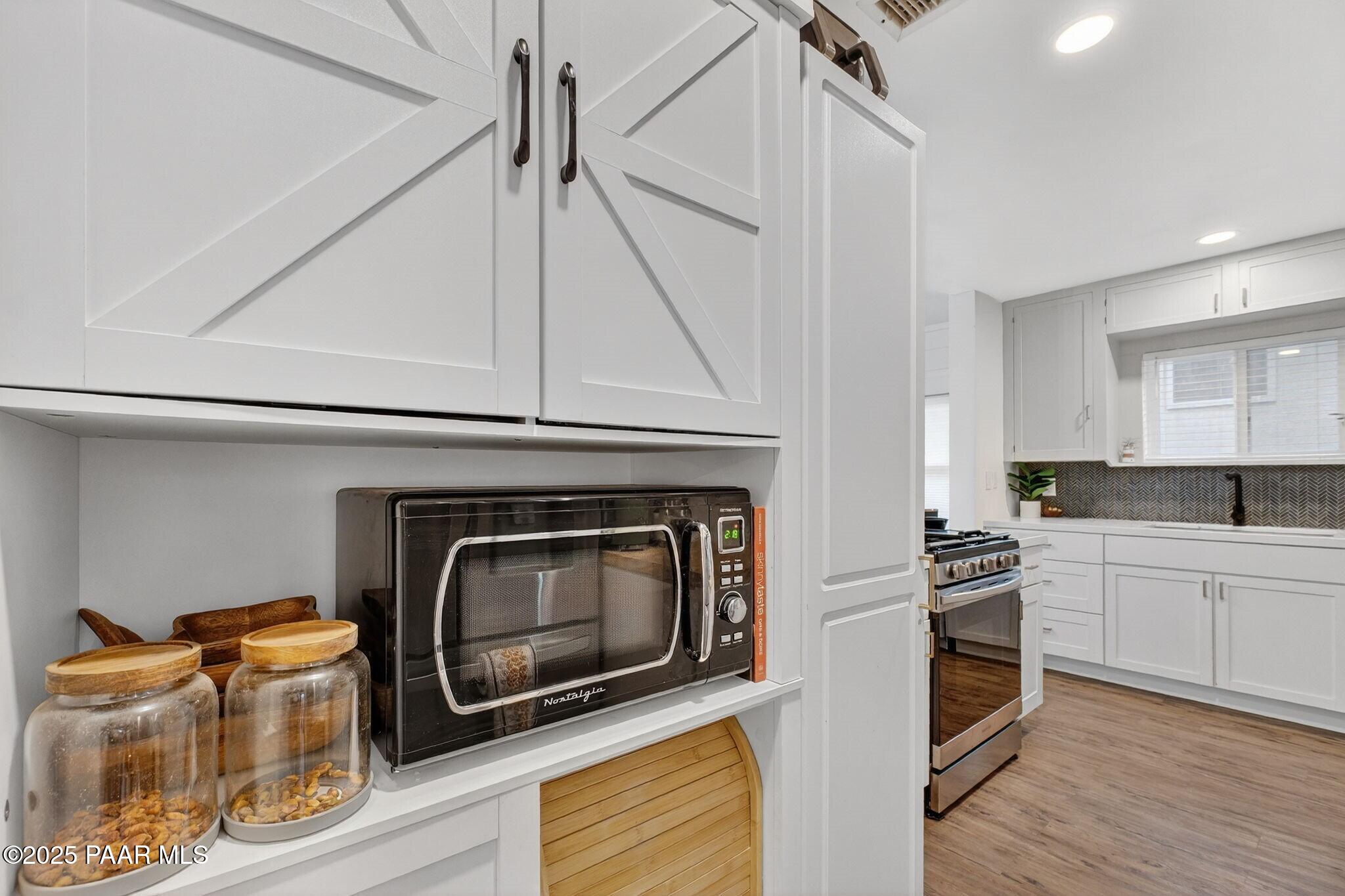730 4th Street Prescott, AZ 86301 - Photo 15 of 37 a kitchen with granite countertop a stove top oven and cabinets