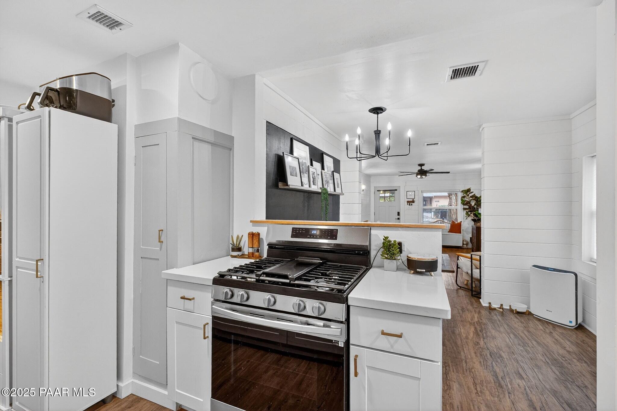 730 4th Street Prescott, AZ 86301 - Photo 16 of 37 a kitchen with a stove and white cabinets