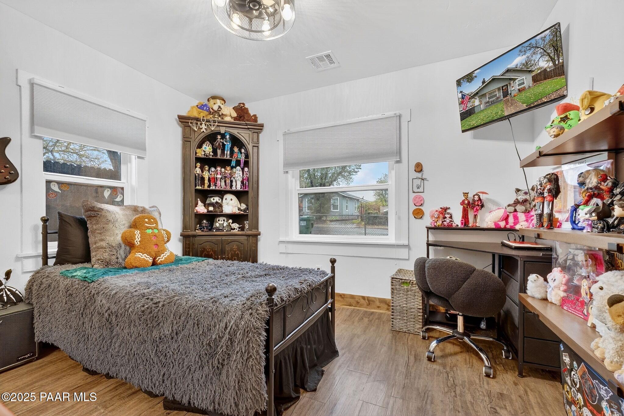 730 4th Street Prescott, AZ 86301 - Photo 21 of 37 a bedroom with a bed a books bucket with desk and chair