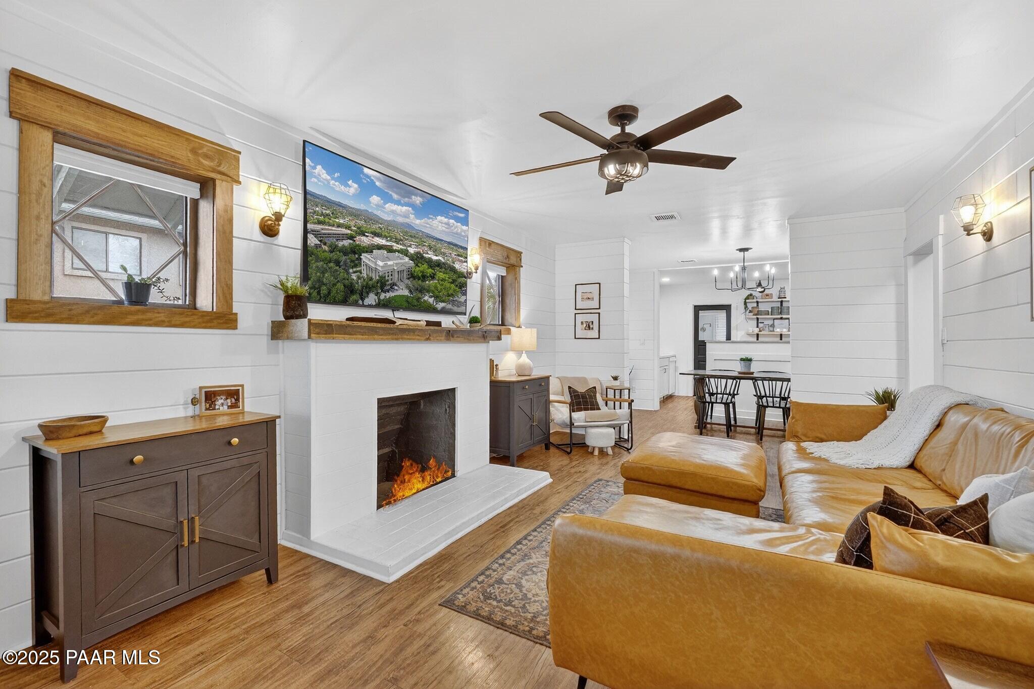 730 4th Street Prescott, AZ 86301 - Photo 4 of 37 a living room with furniture a fireplace and a flat screen tv