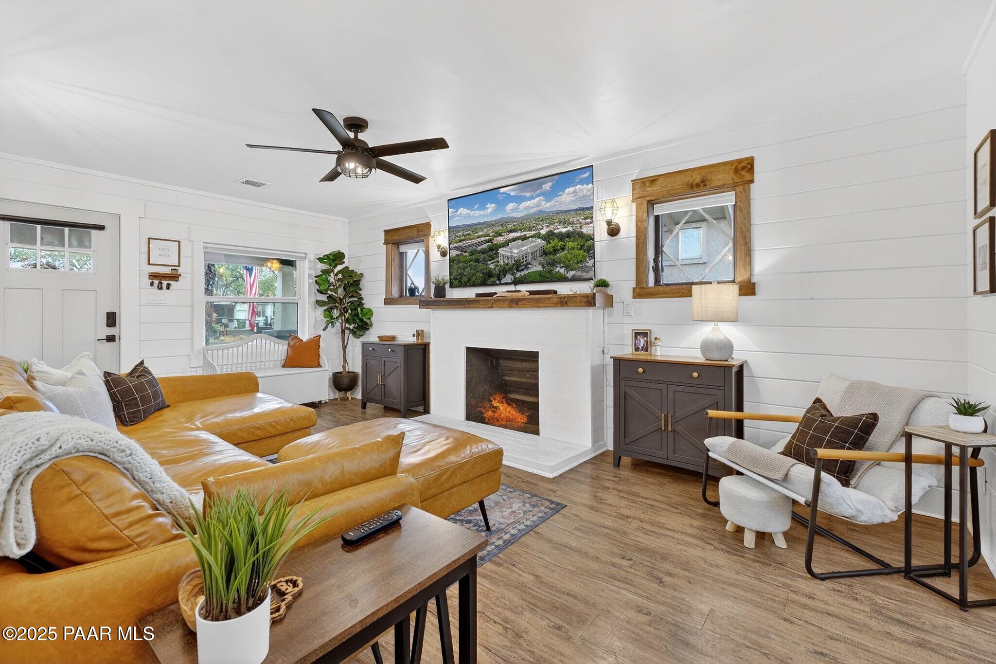 730 4th Street Prescott, AZ 86301 - Photo 9 of 37 a living room with furniture a fireplace and a flat screen tv