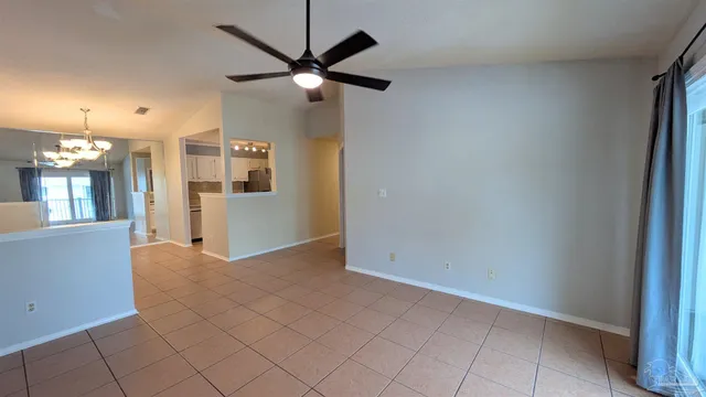 an empty room with fan and entrance