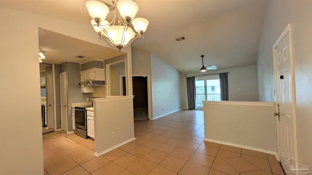 a view of a kitchen with a sink and a refrigerator