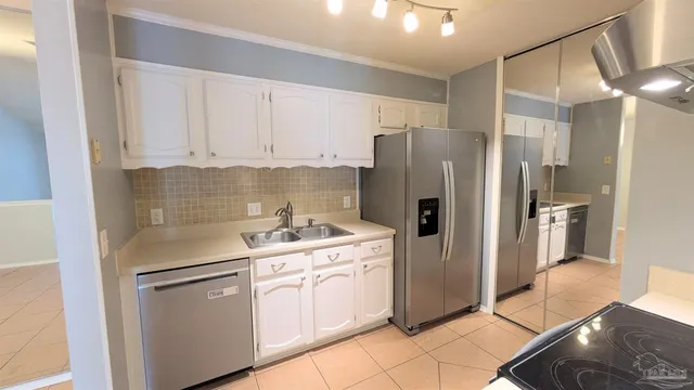 a kitchen with stainless steel appliances a refrigerator sink and cabinets