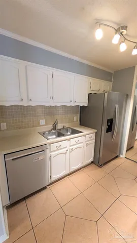 a kitchen with stainless steel appliances granite countertop a refrigerator sink and cabinets