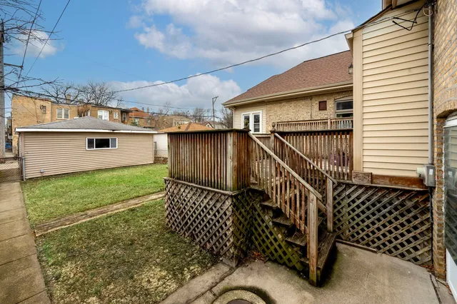 a view of a backyard with a small deck