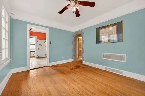 a view of empty room with wooden floor