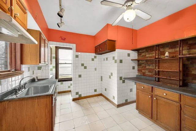 a kitchen with stainless steel appliances a stove a sink and cabinets