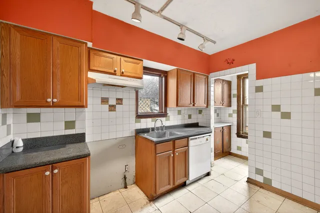 a kitchen with stainless steel appliances granite countertop a sink and cabinets