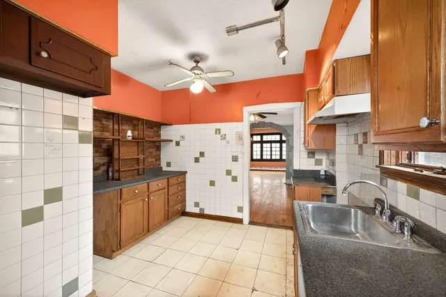a kitchen with stainless steel appliances granite countertop a sink and a refrigerator