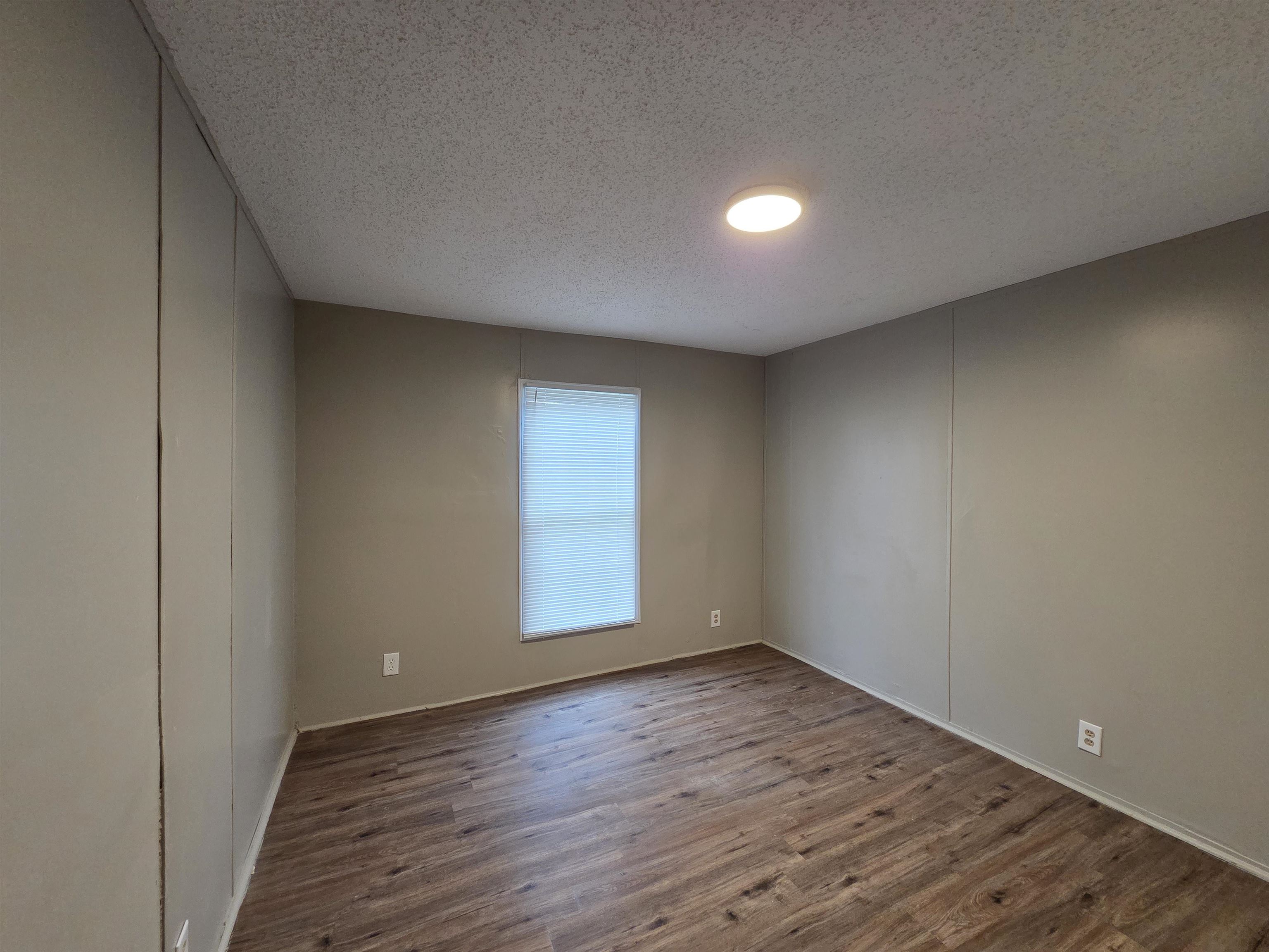 2956 Lake Park Road Memphis, TN 38127 - Photo 12 of 25 an empty room with wooden floor and windows