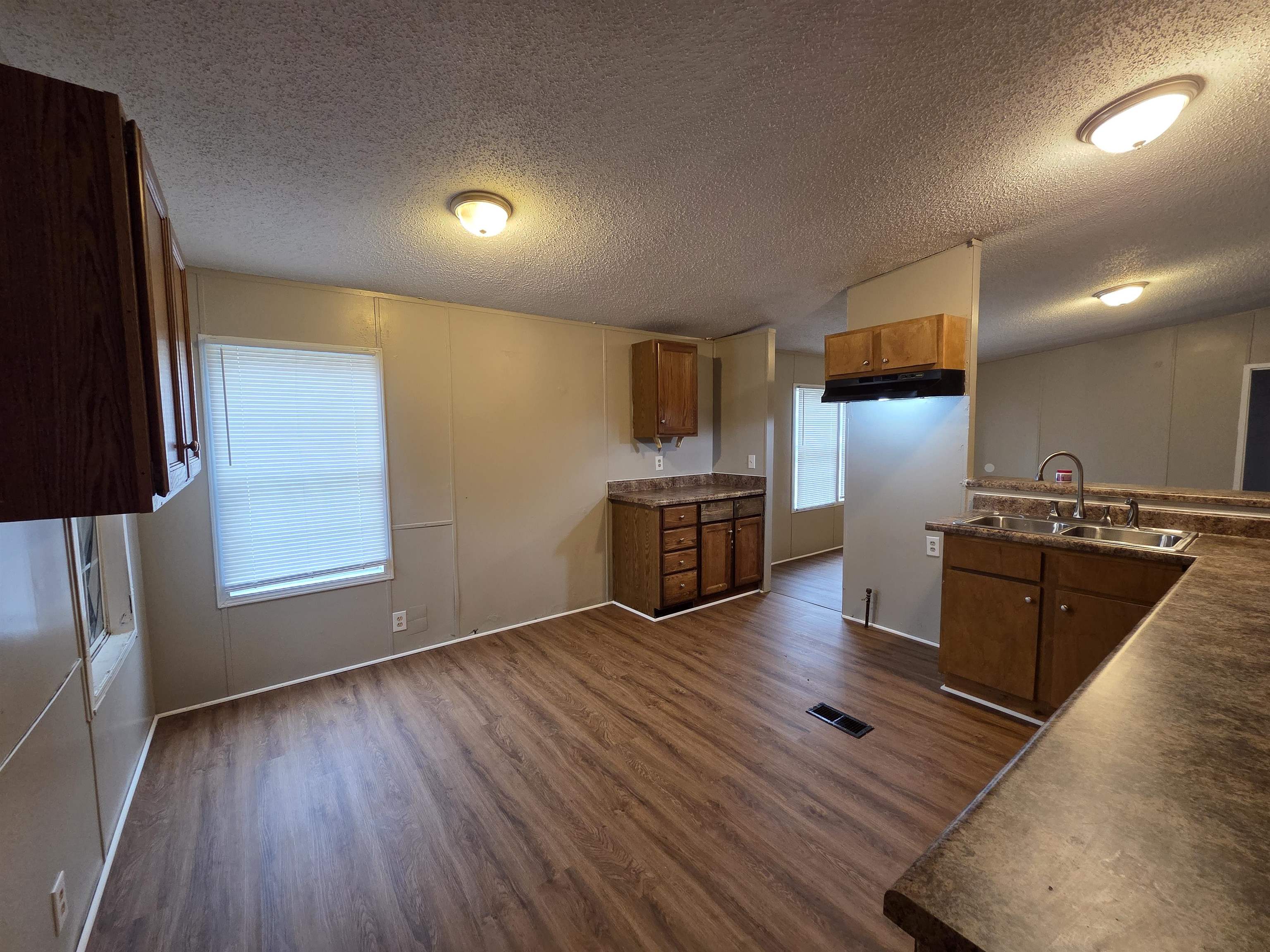 2956 Lake Park Road Memphis, TN 38127 - Photo 14 of 25 a kitchen with wooden floors and stainless steel appliances