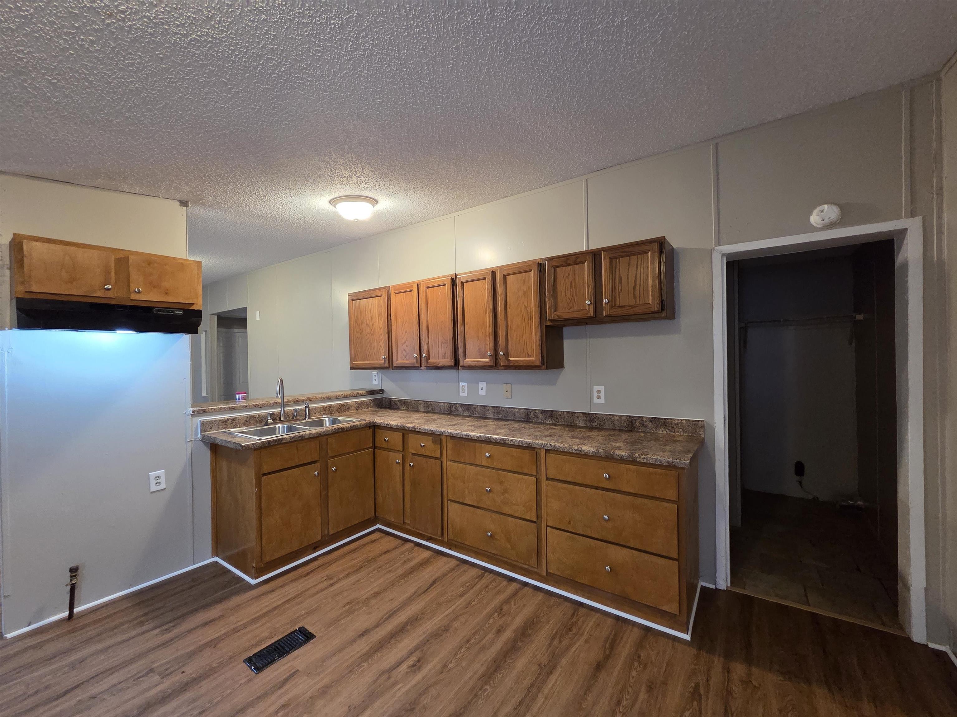 2956 Lake Park Road Memphis, TN 38127 - Photo 15 of 25 a kitchen with stainless steel appliances granite countertop a sink cabinets and wooden floor
