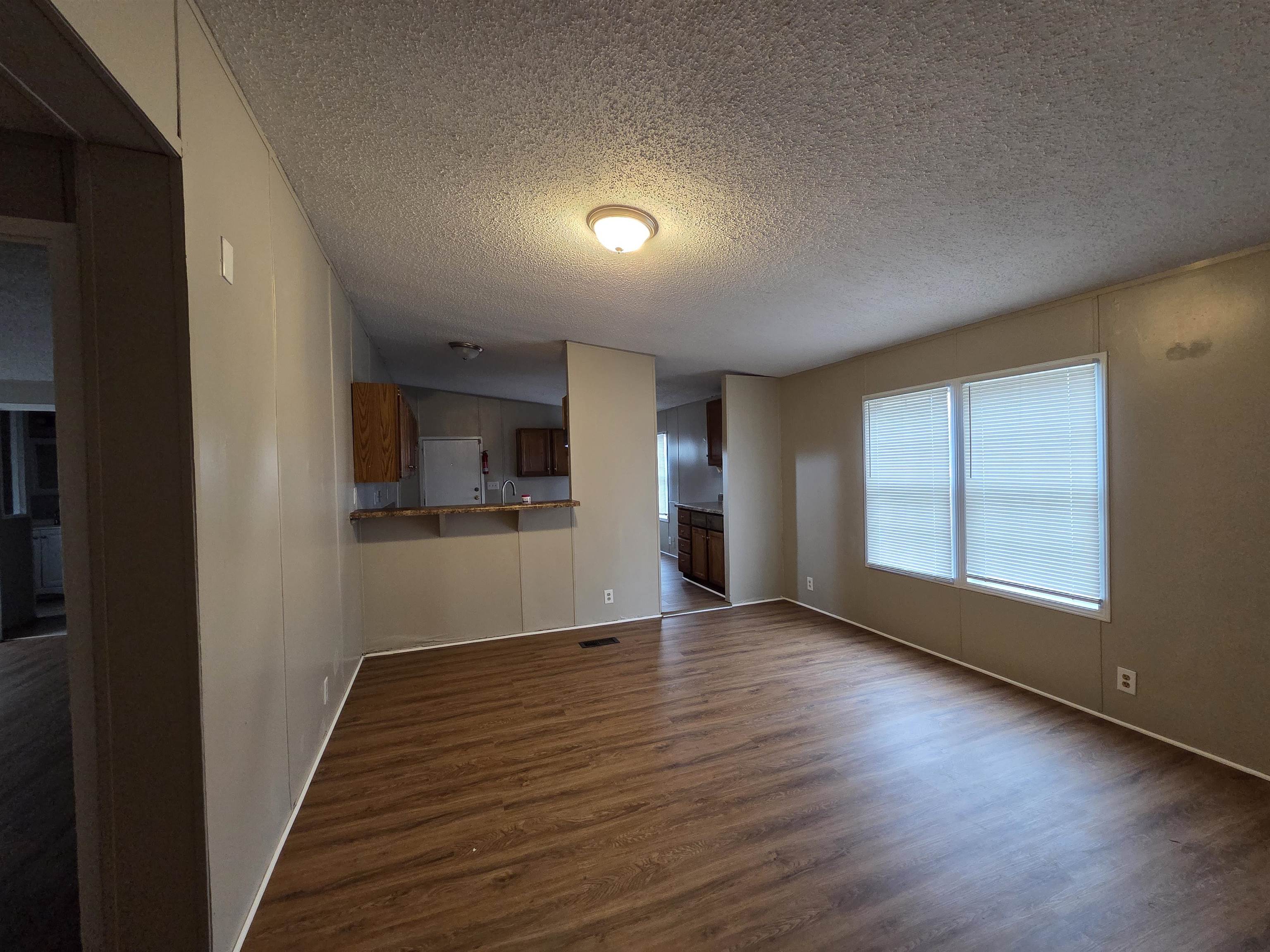 2956 Lake Park Road Memphis, TN 38127 - Photo 9 of 25 an empty room with wooden floor and windows