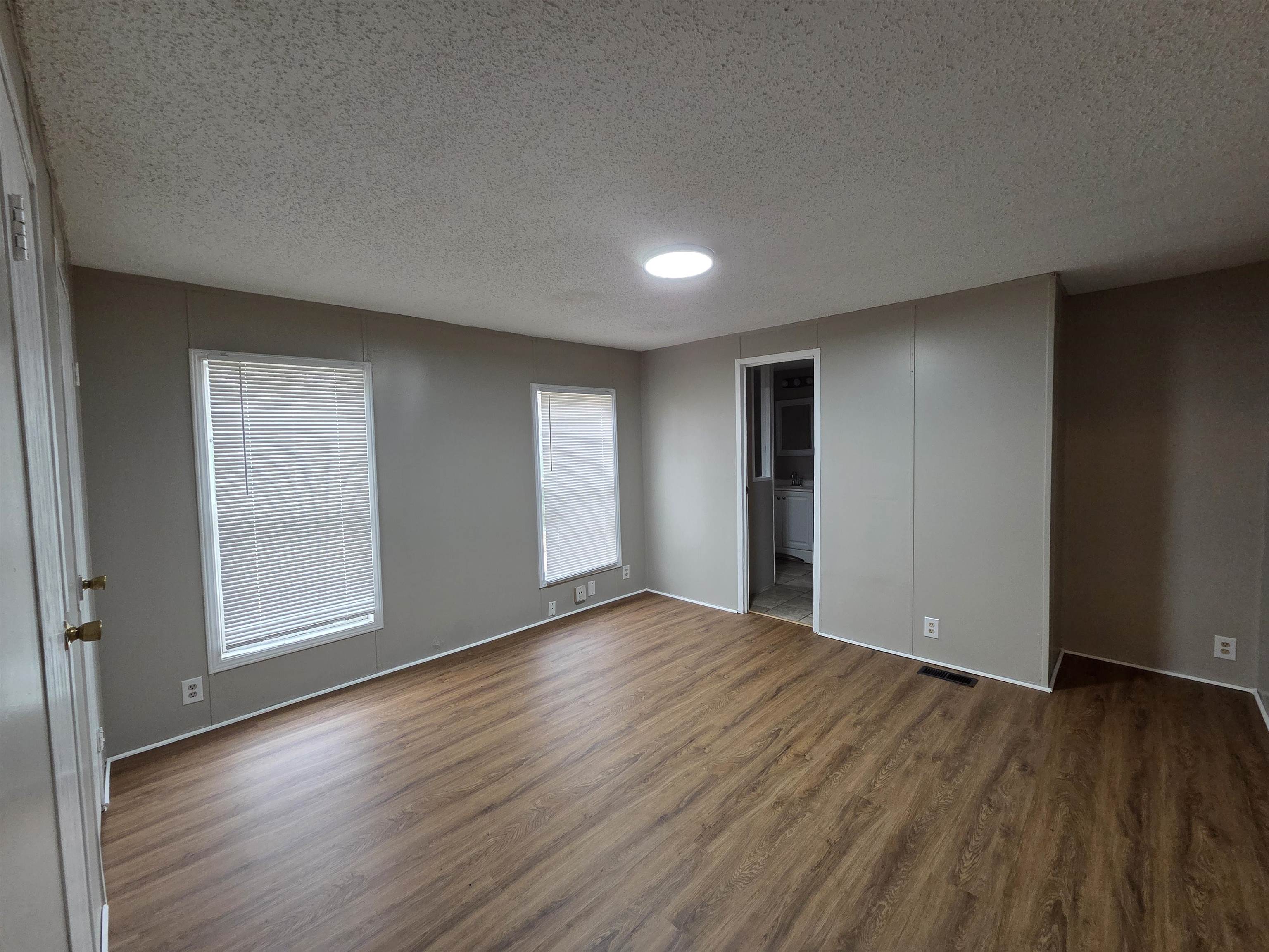 2956 Lake Park Road Memphis, TN 38127 - Photo 10 of 25 an empty room with wooden floor and windows