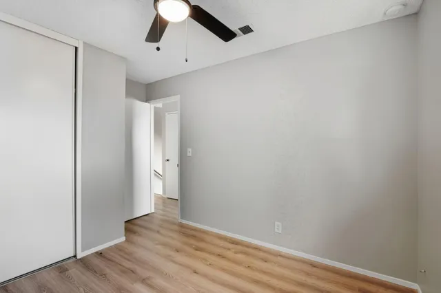 a view of an empty room with wooden floor